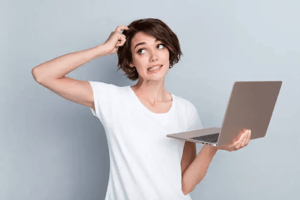 Person thinking while holding a laptop